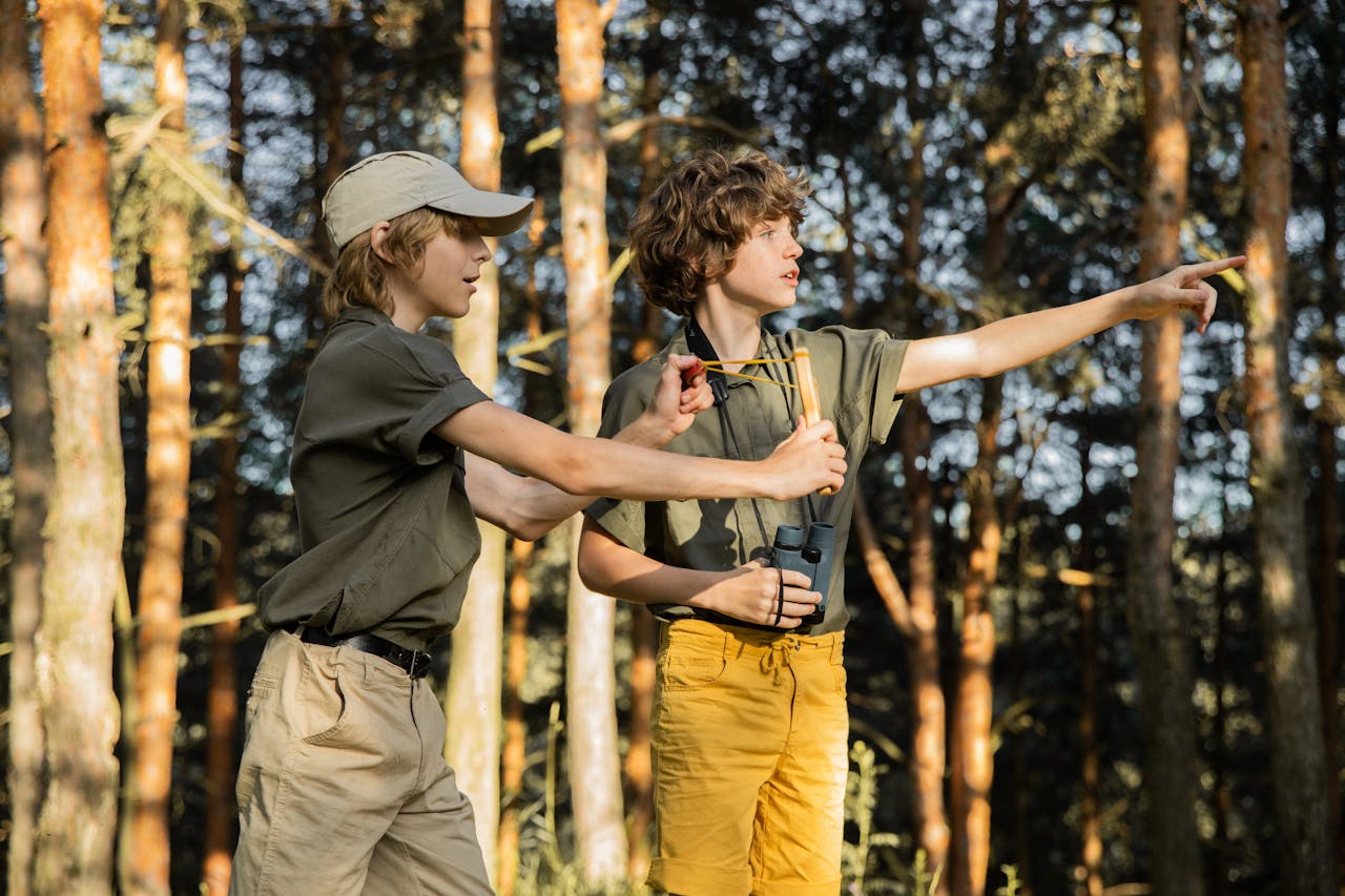 children practicing slingshot target shooting to improve focus and coordination outdoors